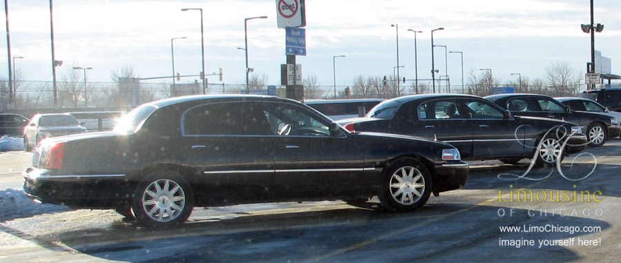 3 Town Cars in the airport parking lot of O'Hare International Airport