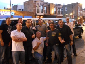 Bachelor party guys in front of SUV stretch limousine at Chicago bar