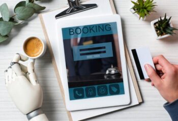 partial view of businessman with cyborg hand holding credit card and using digital tablet making reservation for Limo Service
