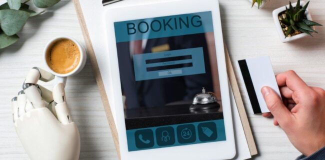 partial view of businessman with cyborg hand holding credit card and using digital tablet making reservation for Limo Service
