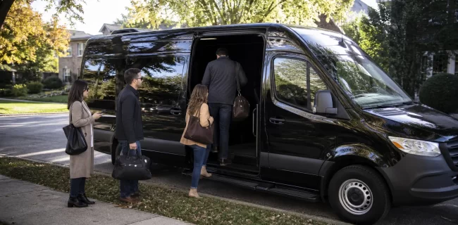 Suburban group boarding a black executive van for a Chicago event