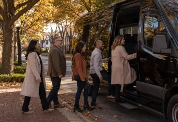 A suburban group boarding a black executive van on an autumn afternoon