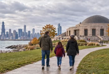 A family walks toward Adler Planetarium beside the Chicago lakefront
